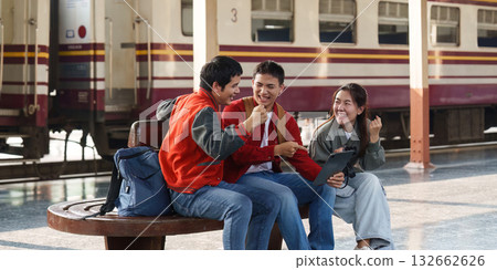 Friendship and Connection. Young adults enjoying time together at a train station. Friendship and Connection. Young adults enjoying time together at a train station. 132662626