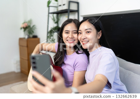 LGBTQIA Couple Smiling Together While Taking Selfie LGBTQIA Couple Smiling Together While Taking Selfie 132662639