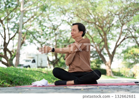 Mindfulness and Flexibility. Senior man stretching during outdoor yoga practice. Mindfulness and Flexibility. Senior man stretching during outdoor yoga practice. 132662681