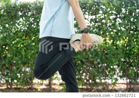 Wellness and Senior Stretching. A senior practicing a stretching routine to enhance flexibility. 132662721