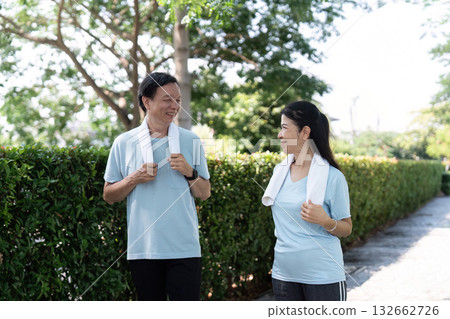 Wellness and Senior Fitness. A couple enjoying a friendly walk together in a park. 132662726