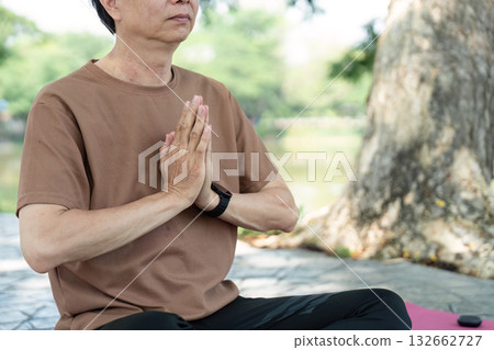 Wellness in Yoga: Senior man meditating with hands in prayer Wellness in Yoga: Senior man meditating with hands in prayer 132662727