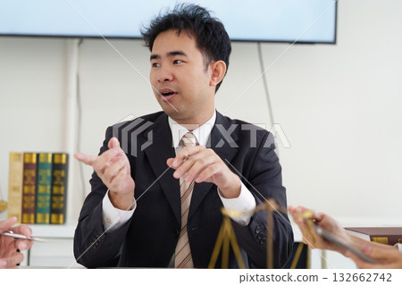Lawyer and Client Interaction. A lawyer explaining legal concepts and strategies during a client meeting. Lawyer and Client Interaction. A lawyer explaining legal concepts and strategies during a client meeting. 132662742