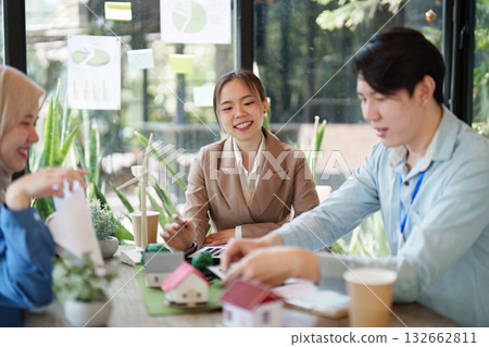 Collaboration and Sustainability. A team discusses eco-friendly architecture in a meeting surrounded by greenery. Collaboration and Sustainability. A team discusses eco-friendly architecture in a meeting surrounded by greenery. 132662811
