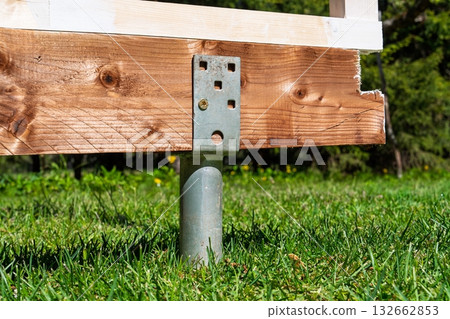 Wooden Deck Support Post on Green Lawn, Enhancing Outdoor Living Spaces with Durability 132662853
