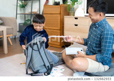 Father and son preparing for school with joyful interactions 132662933