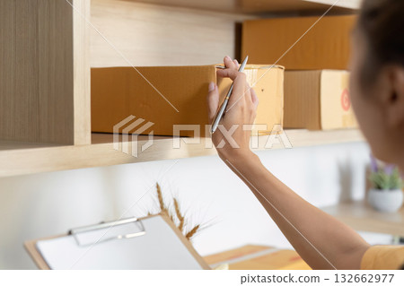 Entrepreneur organizing inventory in a stylish office 132662977