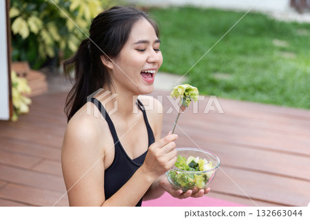 Joyful Eating Experience. Woman laughing while enjoying salad outdoors. Joyful Eating Experience. Woman laughing while enjoying salad outdoors. 132663044