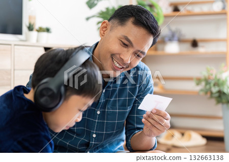 Back to School and Creative Learning. A father reviews educational materials with his son at home. Back to School and Creative Learning. A father reviews educational materials with his son at home. 132663138