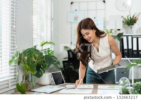 Business sustainability planning with young woman in an eco-friendly office Business sustainability planning with young woman in an eco-friendly office 132663217