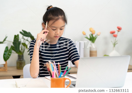 Back to School and Learning. Young girl studying with focus at home, engaging in educational activities. Back to School and Learning. Young girl studying with focus at home, engaging in educational activities. 132663311