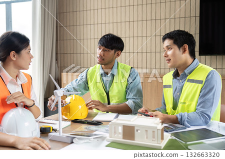 Sustainable Construction Planning. Team of engineers discussing eco-friendly building design. 132663320