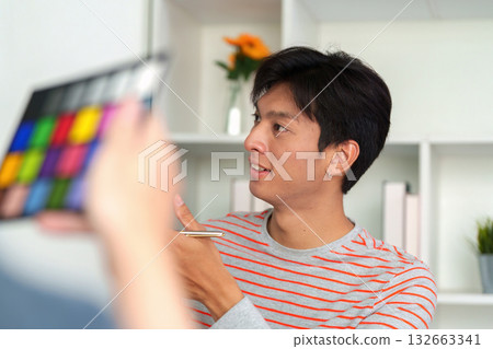 Creativity in Action. A designer analyses colors during a brainstorming session in the office. 132663341