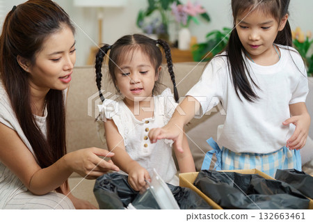 Sustainability and Family Engagement. A mother and children exploring sustainable packaging together. 132663461