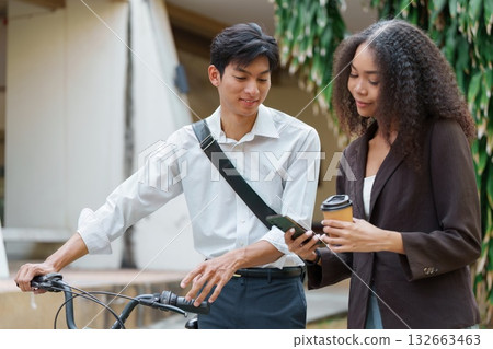 Sustainable Transportation and Digital Connection. Two friends engage in a lively discussion while enjoying their eco-friendly commute. 132663463
