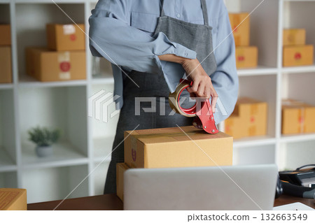 Packing and Preparation. A diligent seller packaging orders for shipment. Packing and Preparation. A diligent seller packaging orders for shipment. 132663549