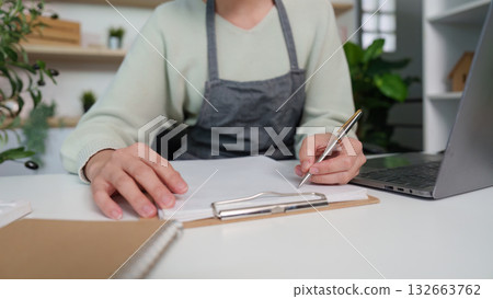Focused Individual Writing in a Modern Office Setting 132663762