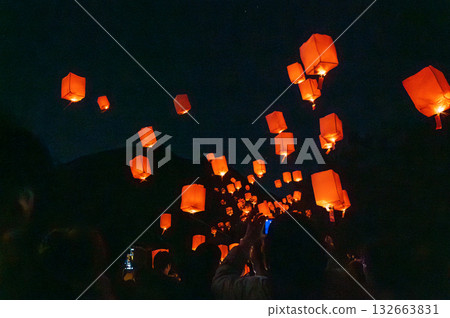 Sky lanterns and people floating in the night sky Sky lanterns and people floating in the night sky 132663831