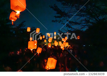 Sky lanterns and people floating in the night sky Sky lanterns and people floating in the night sky 132663839