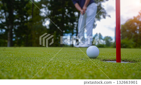 Golf ball is on a green lawn in a beautiful golf course with morning sunshine. 132663901