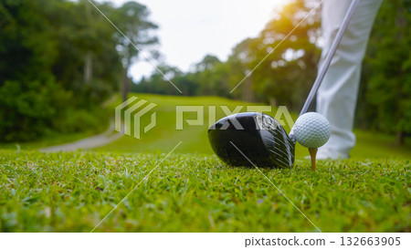 Golfer playing golf in the evening golf course, on sun set evening time. Golfer playing golf in the evening golf course, on sun set evening time. 132663905