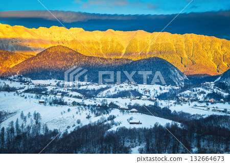 Winter landscape with high snowy mountains at sunrise, Carpathians, Romania 132664673