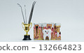 Dental Tools in Trophy with Tooth Anatomy Model and Cartoon Tooth 132664823