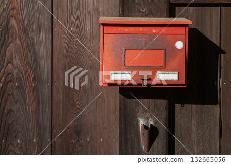 Red mailbox on wooden wall of Japanese home at Kitsuki town, Oita 132665056