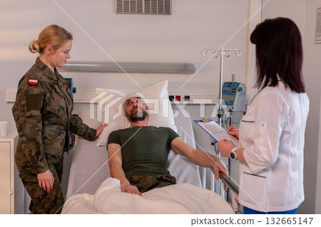 Military Personnel Are Visiting an Injured Soldier Who Is Currently in Their Hospital Bed 132665147