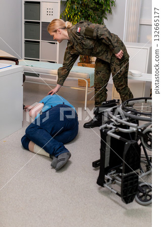 Military Personnel Assisting an Injured Individual During Controlled Training Exercises 132665177