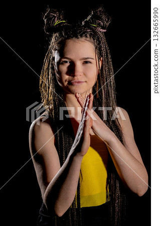 A young woman showcasing a unique hairstyle and a vibrant outfit that stands out 132665990