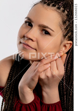 A Young Woman with Stunning Braided Hair Posing Gracefully and Elegantly for the Camera 132666015