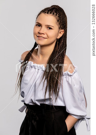 This is a beautiful portrait of a young woman showcasing her braided hair and stylish attire This is a beautiful portrait of a young woman showcasing her braided hair and stylish attire 132666028