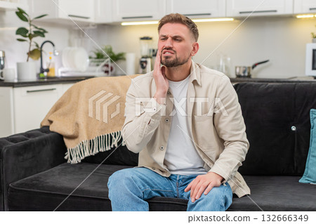 Young man with strong tooth pain covers cheek grimaces massages temple tries to ease sharp ache care Young man with strong tooth pain covers cheek grimaces massages temple tries to ease sharp ache care 132666349