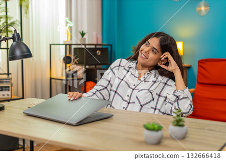 Indian woman closes laptop satisfied project finished relaxes big calm relief enjoying leisure break Indian woman closes laptop satisfied project finished relaxes big calm relief enjoying leisure break 132666418