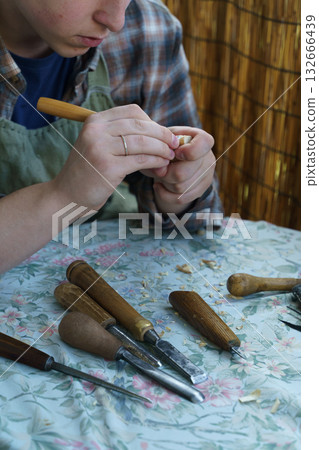 Man Carving Wood by Hand. Traditional Woodworking and Craftsmanship Tools Man Carving Wood by Hand. Traditional Woodworking and Craftsmanship Tools 132666439