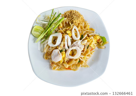 Thai-style stir-fried noodles with squid, tofu, egg, bean sprouts, and crushed peanuts, served with lime and chives on a white plate. Traditional Thai street food known for its balance of sweet, sour, Thai-style stir-fried noodles with squid, tofu, egg, bean sprouts, and crushed peanuts, served with lime and chives on a white plate. Traditional Thai street food known for its balance of sweet, sour, 132666461