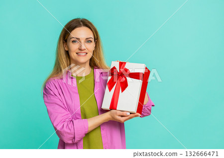 Woman opening gift box with excitement showing joy surprise celebration moment with cheerful smile Woman opening gift box with excitement showing joy surprise celebration moment with cheerful smile 132666471