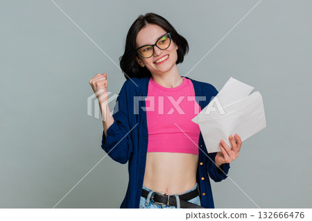 Young woman opening letter gradually smiling more expressing joyful news lottery win test results 132666476