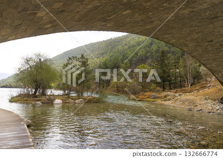 Lijiang, China - April 10, 2024 : A view of a walkway over the lake in Blue Moon Valley in Lijiang, China on April 10, 2024. Lijiang, China - April 10, 2024 : A view of a walkway over the lake in Blue Moon Valley in Lijiang, China on April 10, 2024. 132666774