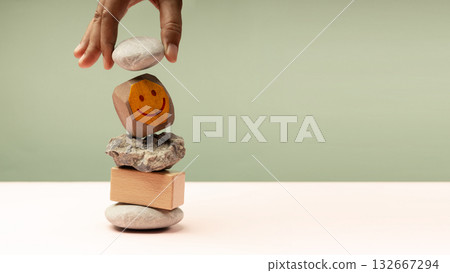Enjoying Life Concept. Harmony and Positive Mind. Hand Setting Natural Pebble Stone, Cement and Wood block Stack 132667294