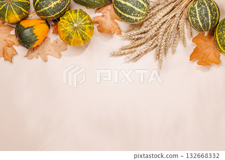 Autumn still life with pumpkins and leaves on beige background Autumn still life with pumpkins and leaves on beige background 132668332