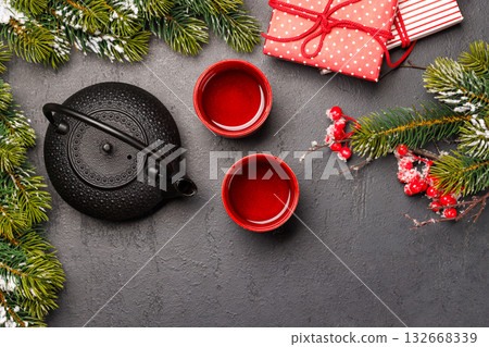 Christmas tea setting with teapot, cups, and fir tree branches Christmas tea setting with teapot, cups, and fir tree branches 132668339