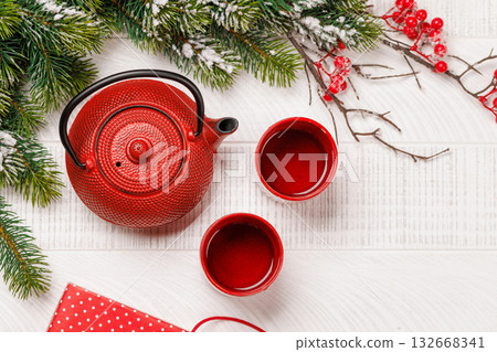 Christmas tea setting with teapot, cups, and fir tree branches Christmas tea setting with teapot, cups, and fir tree branches 132668341