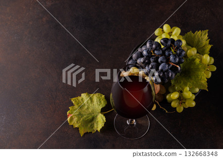 Red wine glass and fresh grapes 132668348