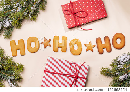 Ginger cookies shaped as Ho Ho Ho with fir branches , Christmas card style 132668354