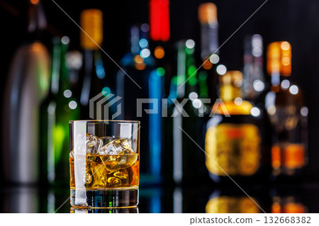 Whiskey on the rocks on a bar table Whiskey on the rocks on a bar table 132668382