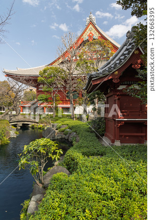 Peaceful Japanese garden with manicured greenery, stone lanterns, and tranquil water elements Peaceful Japanese garden with manicured greenery, stone lanterns, and tranquil water elements 132668395