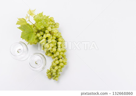 Wine glasses with fresh grapes on a white background, elegant food and drink concept Wine glasses with fresh grapes on a white background, elegant food and drink concept 132668860