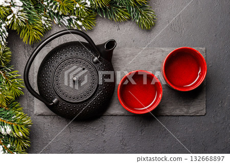 Christmas tea setting with teapot, cups, and fir tree branches Christmas tea setting with teapot, cups, and fir tree branches 132668897